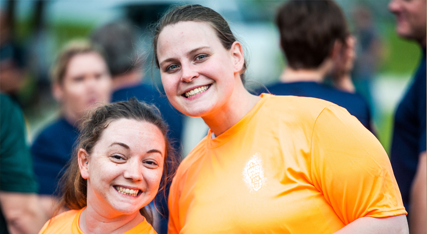 Adult volunteer with smiling child