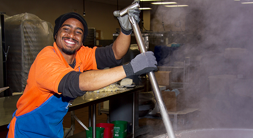 Smiling young man operating foodservice equipment